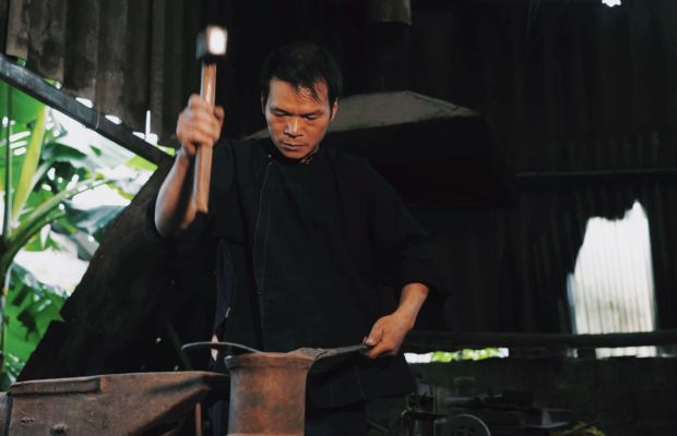 A blacksmith in the Pac Rang Village