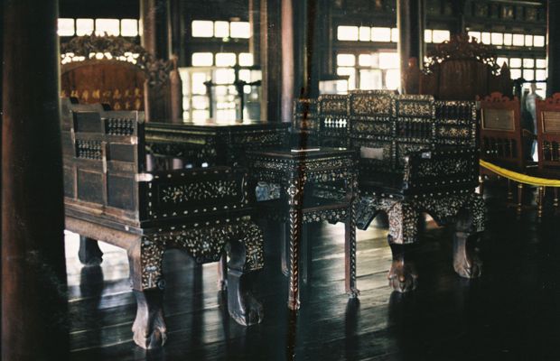 Gilded wooden tables and chairs in the Hue Royal Museum of Antiquities